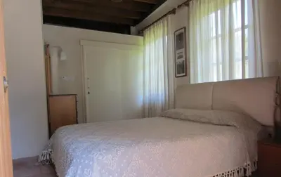a bedroom with a bed and a window at Ayios Andronikos Agrotourism House in Kalopanayiotis