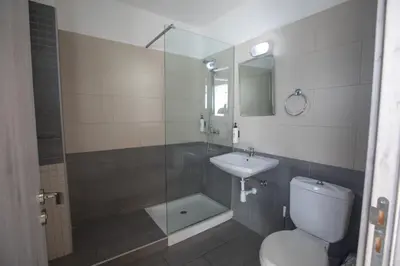 a bathroom with a shower and a toilet and a sink at Pavlinia Hotel & Apartments in Ayia Napa