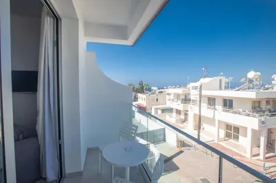 a balcony with a table and a view of a city at Pavlinia Hotel & Apartments in Ayia Napa