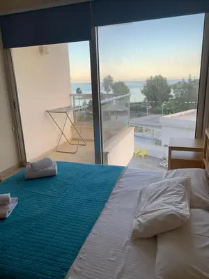 a bedroom with a bed and a large glass window at PALLINIO COURT 402 Fig Tree Bay- Protaras Beach, IASONOS STR 7A in Protaras