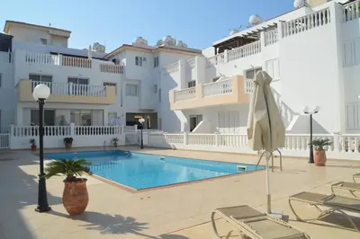 a swimming pool in the middle of a building at Kapparis Penthouse in Paralimni