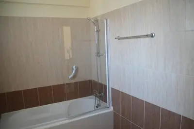 a bathroom with a shower with a tub and a shower at Kapparis Penthouse in Paralimni