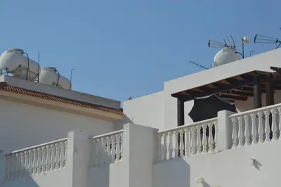 a building with two balconies and two satellite dishes at Kapparis Penthouse in Paralimni