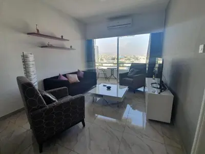 a living room with a couch and chairs and a table at Great views apartment. in Limassol