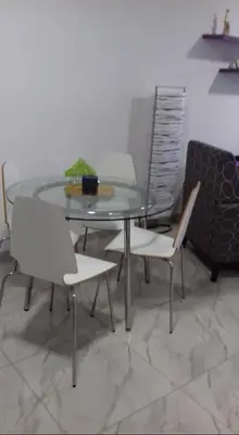 a glass table with two white chairs and a glass table with a glass table at Great views apartment. in Limassol
