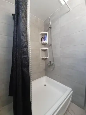 a bathroom with a shower and a white bath tub at Great views apartment. in Limassol