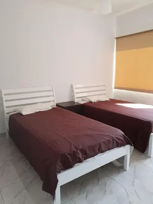 two beds sitting next to each other in a room at Great views apartment. in Limassol