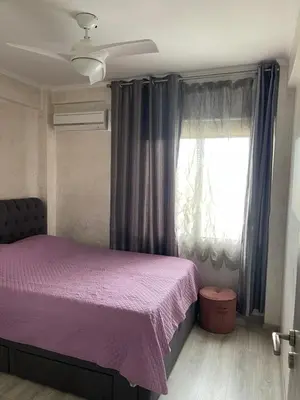 a bedroom with a purple bed and a window at Galaxy court modern apartment in Limassol