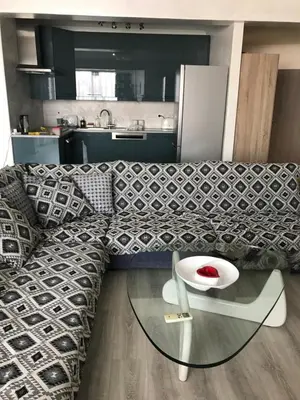a living room with a couch and a glass table at Galaxy court modern apartment in Limassol