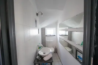 a small white bathroom with a toilet and a sink at Villa Papantonia in Protaras