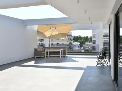 a balcony with a table on a building at BAZ TOWER in Nicosia