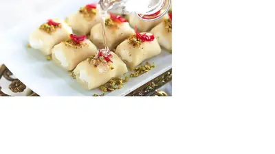 a plate of marshmallows with a sauce being poured on top at City Center Holiday room in Limassol