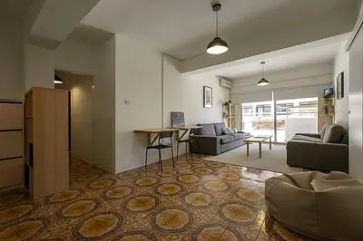 a living room with a couch and a table at White Hostel in Limassol