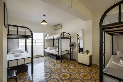 a dorm room with four bunk beds and a hallway at White Hostel in Limassol