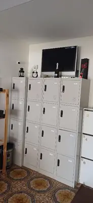 a row of lockers with a television on top of them at White Hostel in Limassol