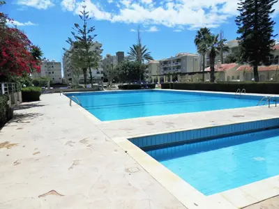 a large swimming pool with blue water at Palm beach 14 in Limassol