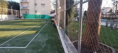 a tennis court with a net on a tennis court at Palm beach 14 in Limassol