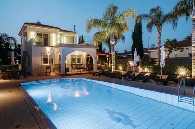 a swimming pool in front of a house at Sunset Villa private complex heated pool in Ayia Napa