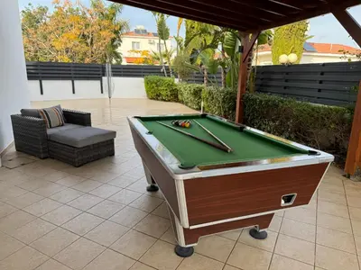 a pool table sitting on top of a patio at Sunset Villa private complex heated pool in Ayia Napa