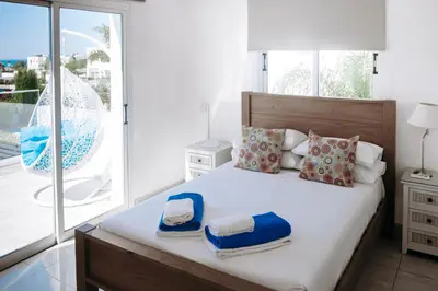 a bedroom with a bed with towels on it at Sunset Villa private complex heated pool in Ayia Napa