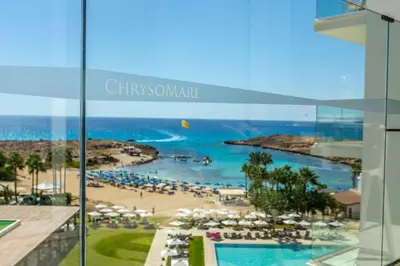 a view of a beach and the ocean from a building at Chrysomare Beach Hotel & Resort in Ayia Napa