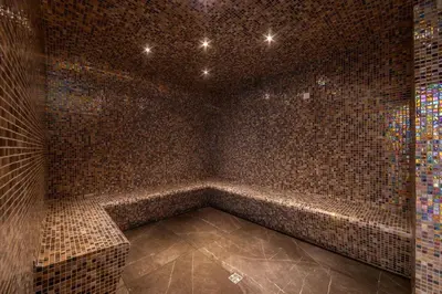 a large room with a tiled wall with a shower at Chrysomare Beach Hotel & Resort in Ayia Napa