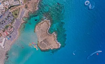 an aerial view of an island in the water at Chrysomare Beach Hotel & Resort in Ayia Napa