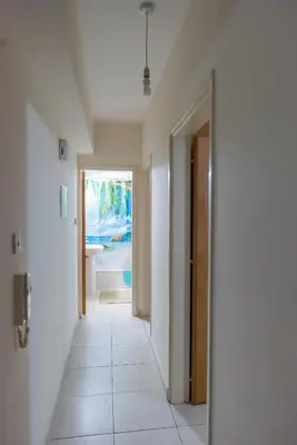 a hallway of a house with a hallway leading to a bathroom at EURO CARISSA FLAT 101 in Larnaka