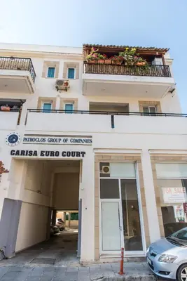 a building with a car parked in front of it at EURO CARISSA FLAT 101 in Larnaka