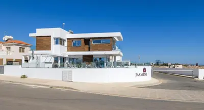 a large white house on the side of a street at Infinity View Villa in Ayia Napa