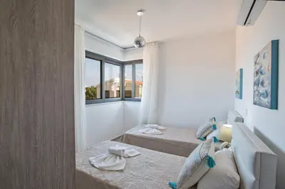 a living room with two beds and a couch at Colour Residences in Protaras
