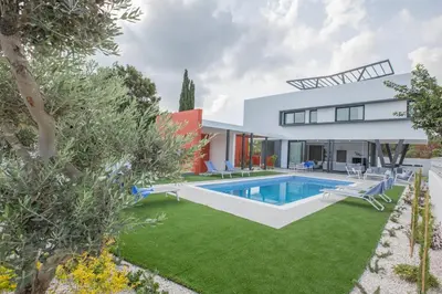 a modern house with a swimming pool and a yard at Colour Residences in Protaras