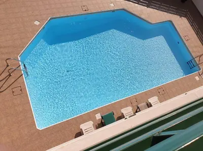 an overhead view of a swimming pool with chairs at Mediterranean dream in Voroklini