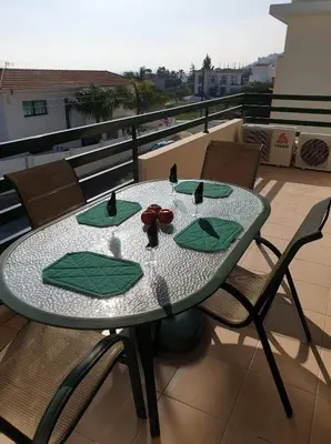 a table on the roof of a balcony with a table and chairs at Mediterranean dream in Voroklini