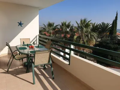 a table and chairs on a balcony with a view at Mediterranean dream in Voroklini