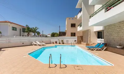 a swimming pool in the backyard of a building at Mediterranean dream in Voroklini