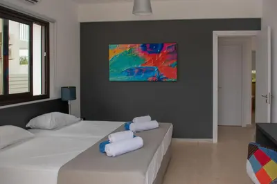 a bedroom with two beds with towels on them at Villa Fortuna in Ayia Napa