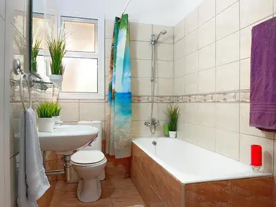 a bathroom with a tub and a toilet and a sink at Central 2 Bedroom Apt Terrace and Pool in Ayia Napa