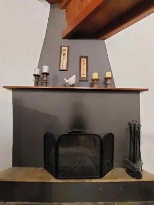 a black fireplace with candles on top of it at Evanthia's Stone House in Koilani