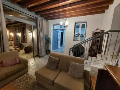 a living room with a couch and a staircase at Evanthia's Stone House in Koilani