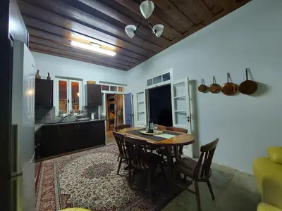 a kitchen and dining room with a table and chairs at Evanthia's Stone House in Koilani