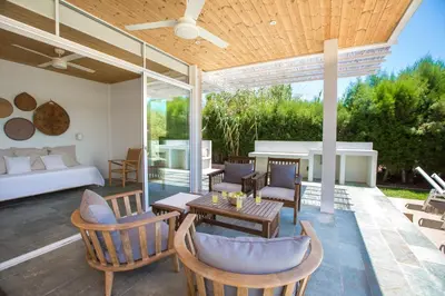 a patio with a couch and a table and chairs at Ayia Napa Villa Danae in Ayia Napa