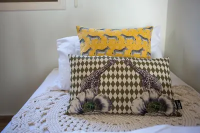 two giraffes on a pillow on a bed at Penthouse Duplex overlooking the Mediterranean in Larnaka