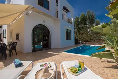 a villa with a swimming pool and a house at Villa Anatoli - Cape Greco in Protaras