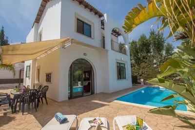 a villa with a pool and a table and chairs at Villa Anatoli - Cape Greco in Protaras