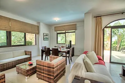 a living room with a couch and a dining room at Villa Anatoli - Cape Greco in Protaras
