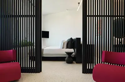 a room with a bed and two red chairs at MAP Boutique Hotel in Nicosia