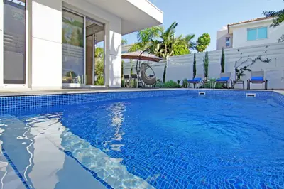 a swimming pool in front of a house at Villa Lily in Protaras