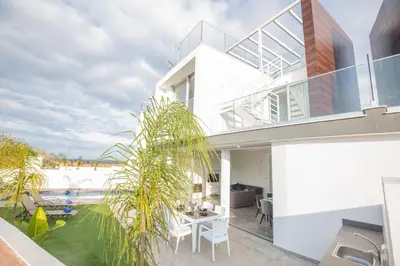 a house with a view of the backyard at Olivine Pearl Villas in Protaras