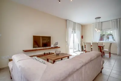 a living room with a couch and a table at Amphitrite Villa in Paralimni